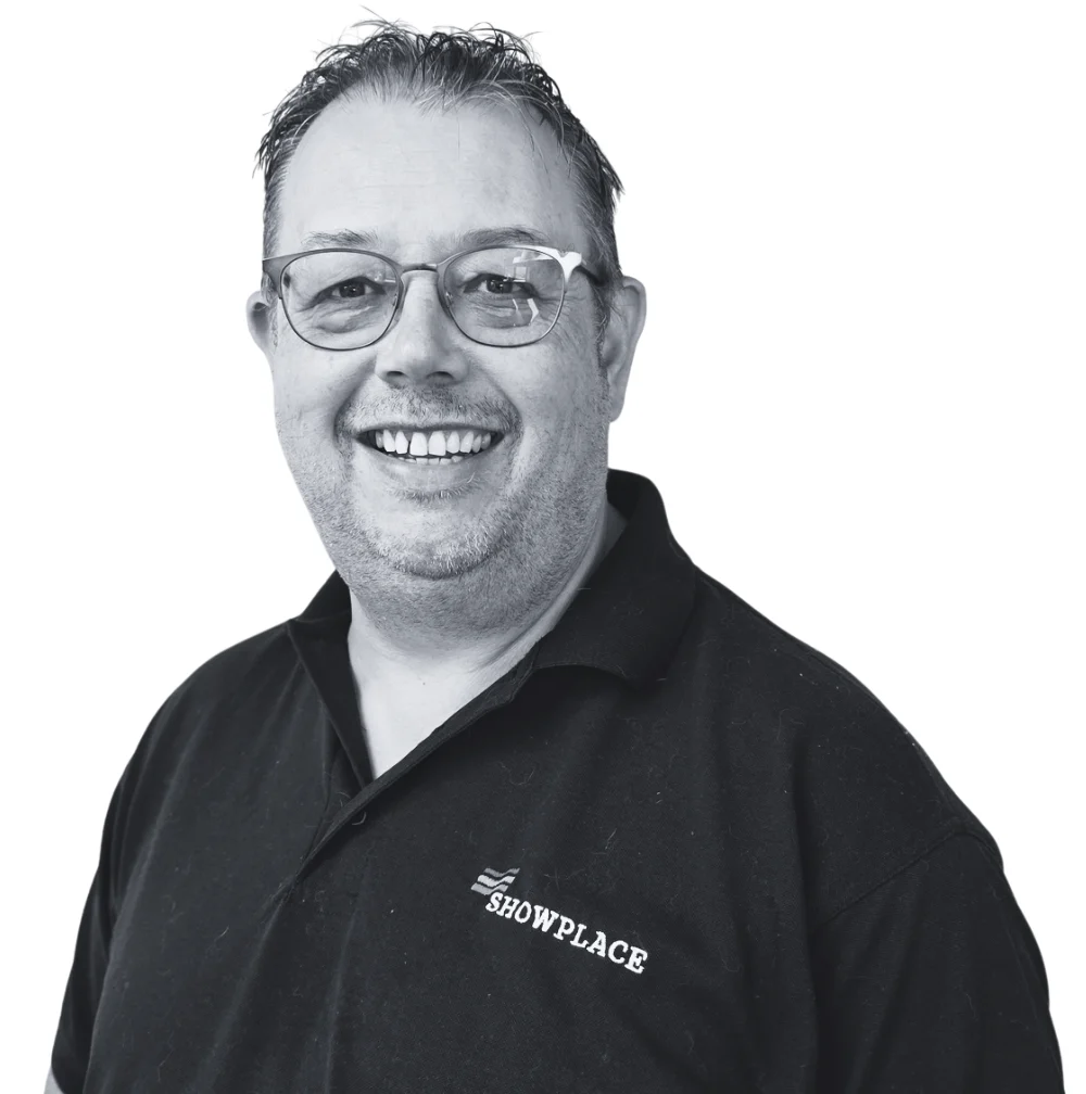 Darren, a smiling man wearing glasses and a black Showplace polo shirt.