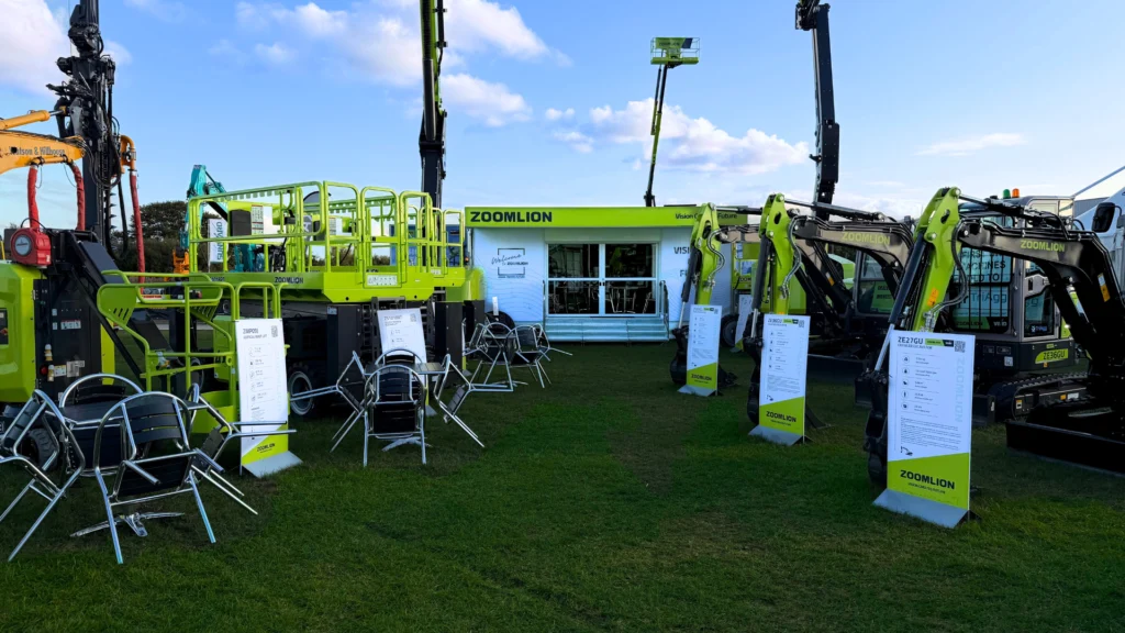 Zoomlion construction machinery and equipment displayed at an outdoor trade show booth.