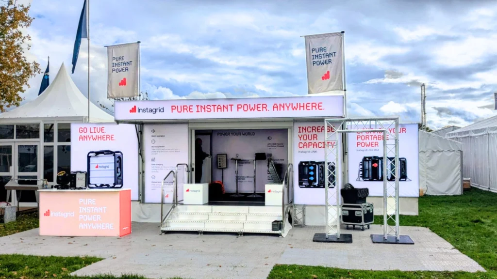 Instagrid promotional booth showcasing portable power solutions at an outdoor event.