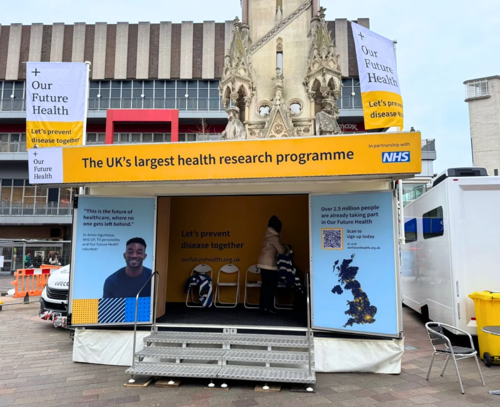 An Our Future Health mobile unit parked in a city square, inviting the public to join the UK health research programme.
