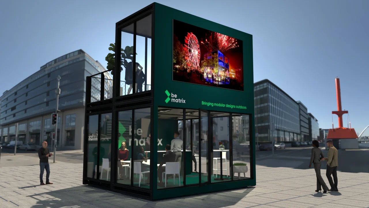 A two-story modular BeMatrix structure with a large digital screen stands in an urban plaza.