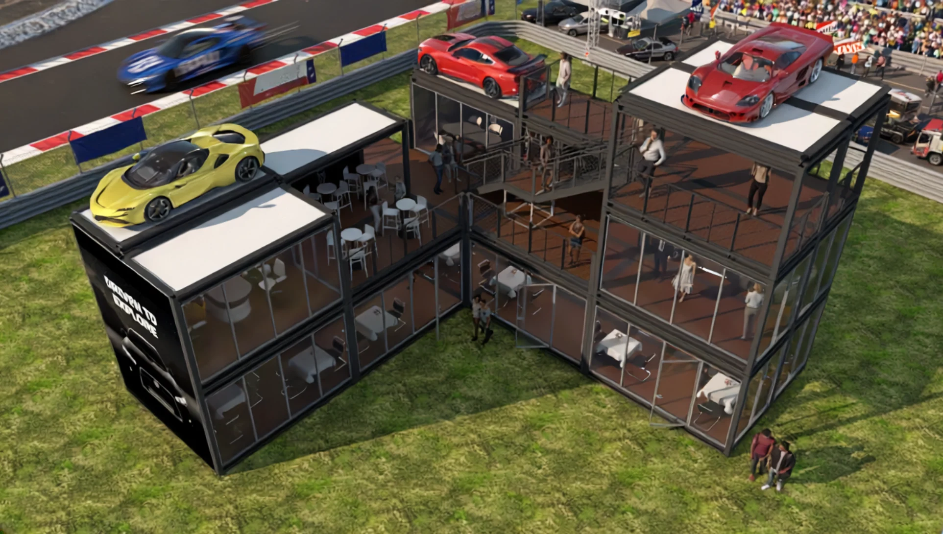 A multi-level hospitality structure made of shipping containers with sports cars on the roof at a racetrack.