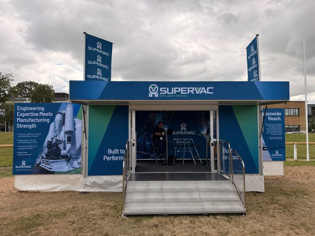 Supervac branded trade show booth featuring engineering and manufacturing services.